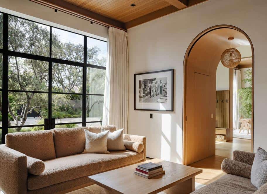 Modern living room with large window, natural light, and contemporary furniture.