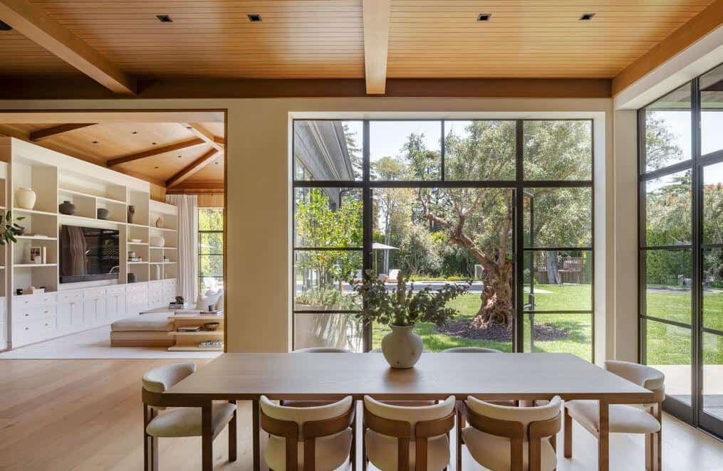 Bright living room with expansive windows and natural light, showcasing modern interior design.