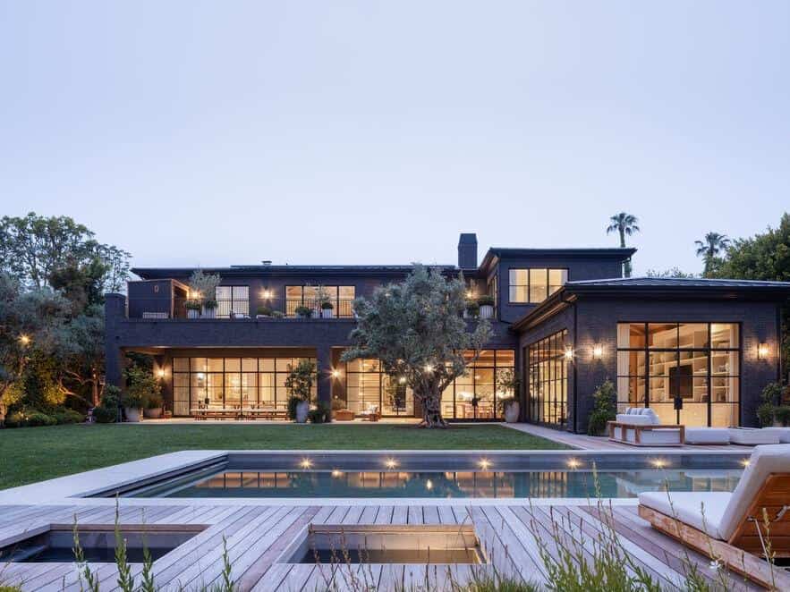 Luxury modern estate with pool, outdoor lounge, and landscaped garden.