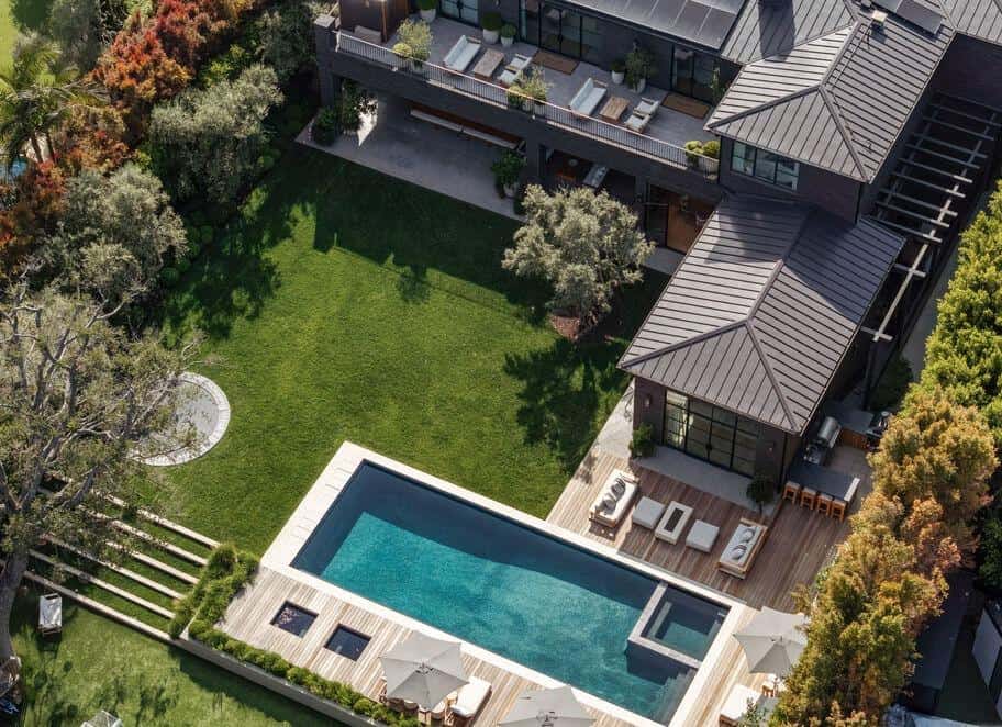 Luxury residential property with swimming pool and outdoor seating area.