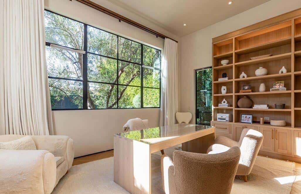 Office meeting room with expansive windows and natural light, featuring wooden shelving and comforta.