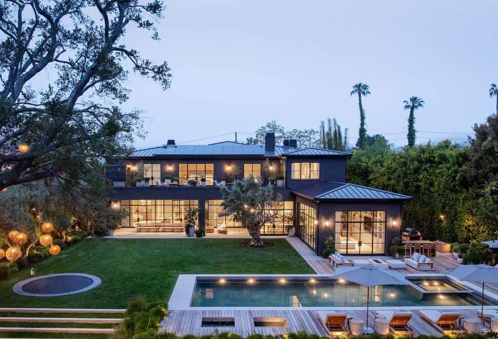 Elegant contemporary residence featuring a spacious backyard with pool and lush landscaping.