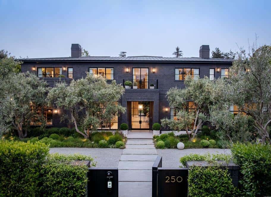 Luxury modern home with sleek black facade and landscaped garden.